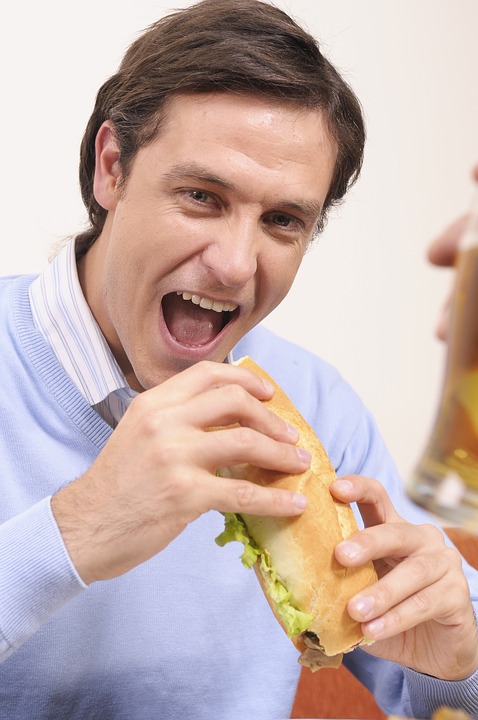 Man Eating a Sandwich - Rival and Excludable